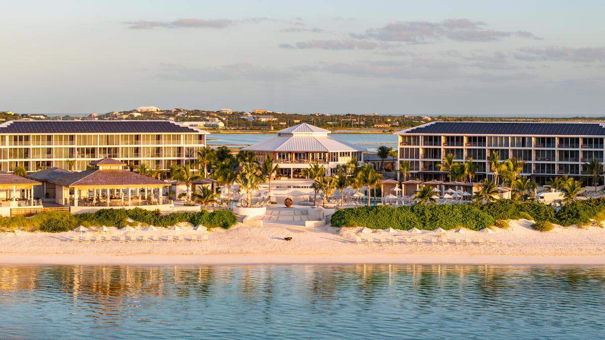 An aerial view of Salterra, a Luxury Collection Resort & Spa, South Caicos, where pristine sands meet turquoise waters on the island’s quiet southeastern shore.