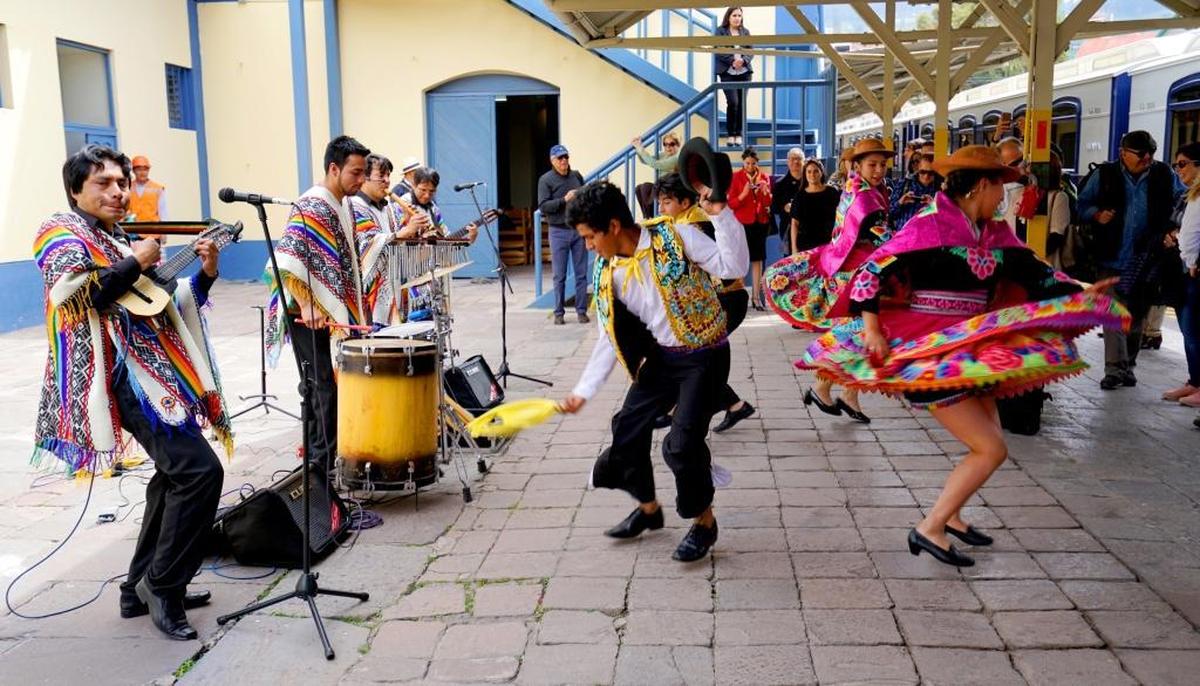 Local native musicians and dancers in traditional costumes welcome guests of the Andean Explorer.