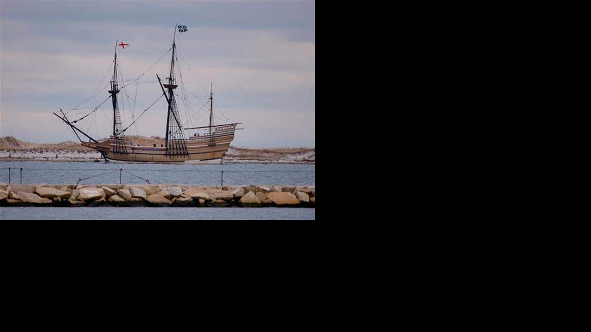 
The Mayflower replica passes through a jetty as it is towed out of Plymouth Harbor on Dec. 12, 2014.

