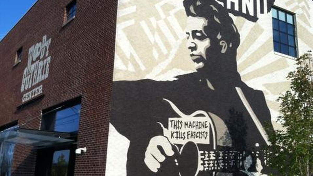 
The Woody Guthrie Center in Tulsa honors the musician’s life and legacy. You'll have to pay to visit the museum but the evocative mural outside lends a distinctive feel to the neighborhood. 
