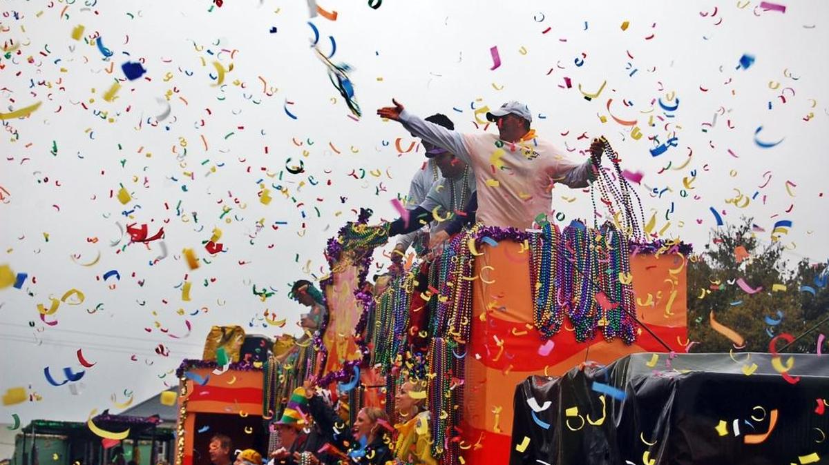 Thrown beads fill the air during a Biloxi Mardi Gras parade.