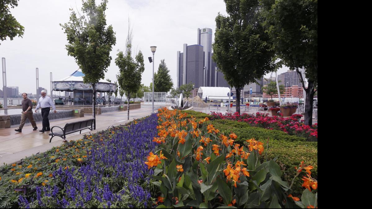 
Walkers stroll on the Detroit RiverWalk.
