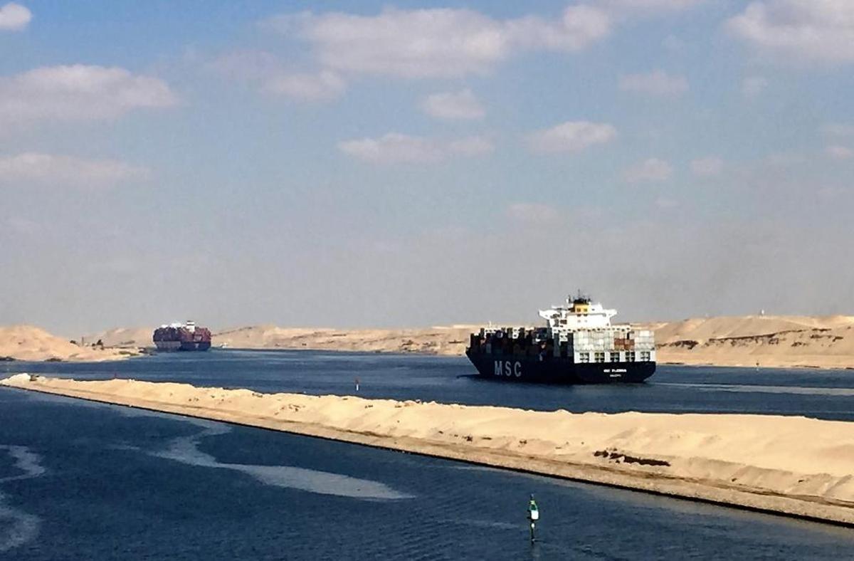 Container ships and tankers in a convoy heading north in the Suez Canal.