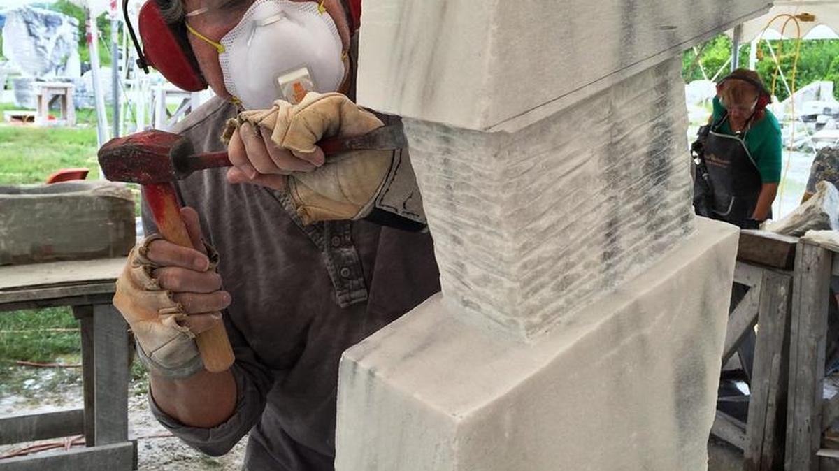 
Chiseling away: Niles Benn, of York, Pennsylvania, works on a marble sculpture during a workshop at the Carving Studio and Sculpture Center in West Rutland, Vermont. 
