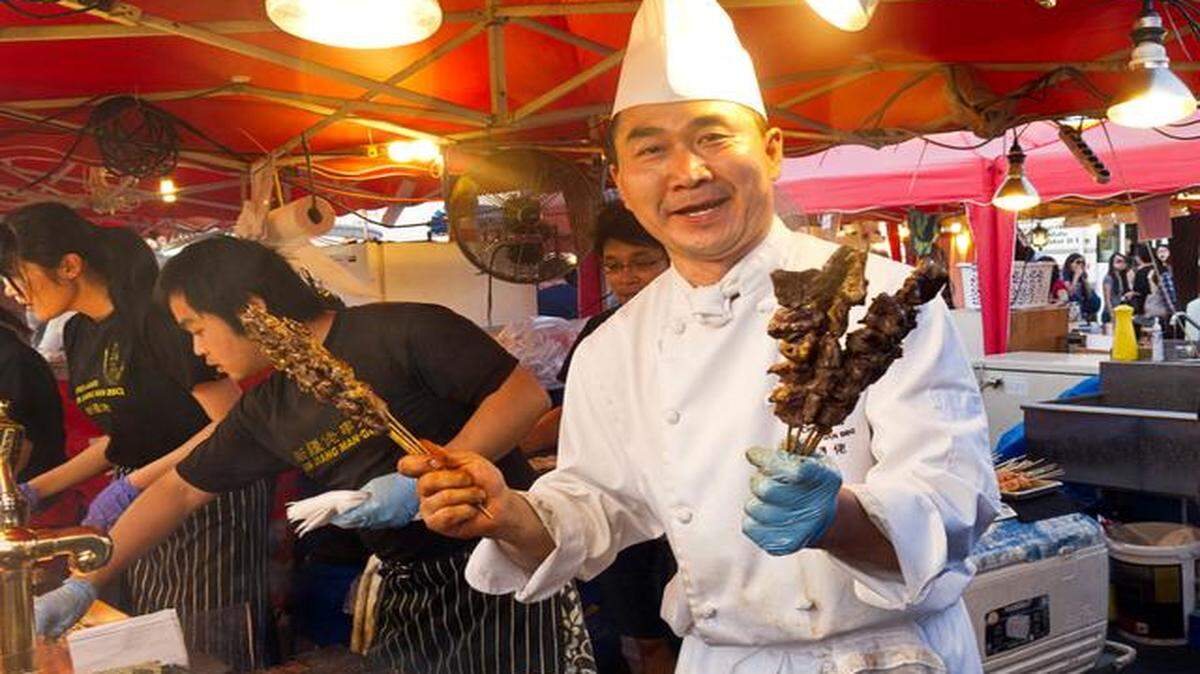 
Cook grills assorted meats (beef, lamb and chicken) along with shrimp at Richmond Night Market, Richmond, British Columbia, Canada.
