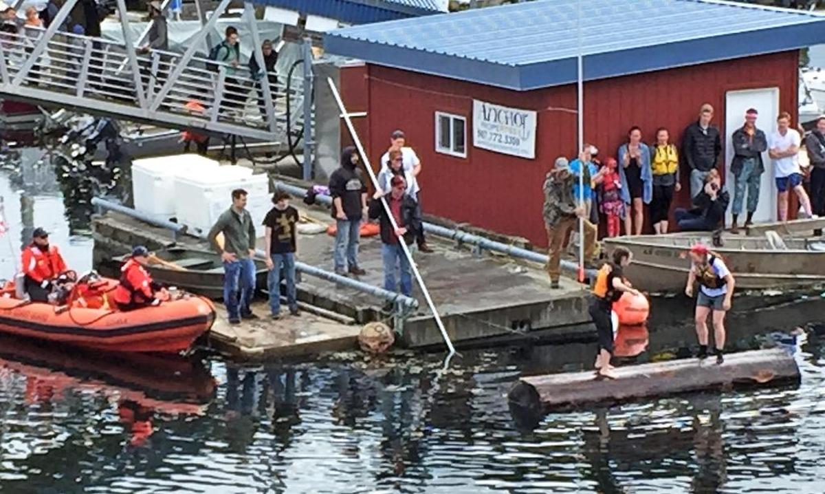 Two women compete to stay dry, while encouraging an opponent to fall off, in the 2017 annual log rolling contest in Petersburg, Alaska.