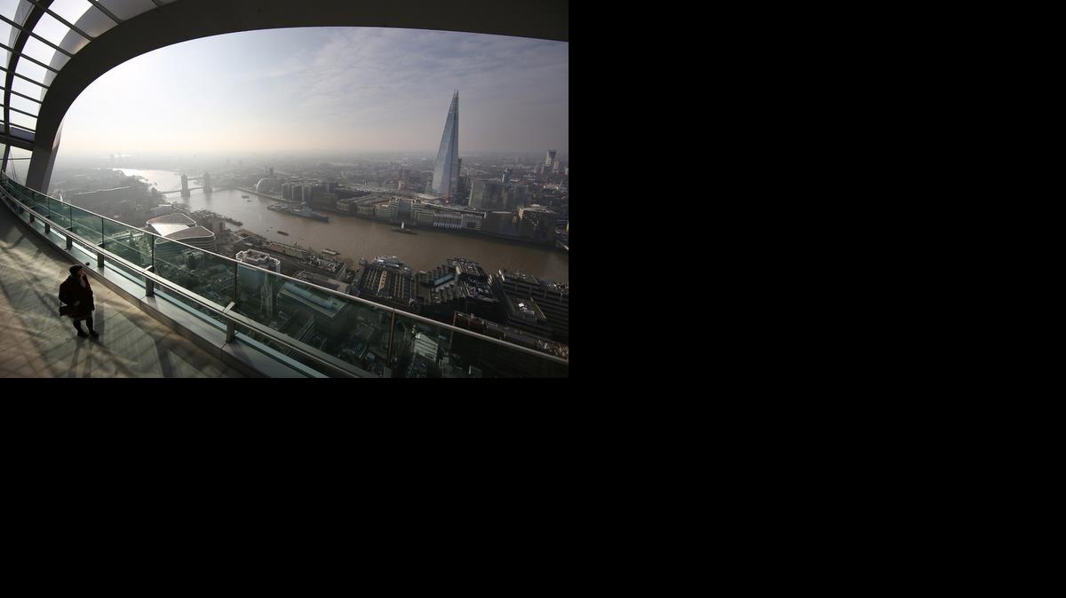 LONDON, ENGLAND - MARCH 12: A visitor looks at the view from the Sky Garden terrace at 20 Fenchurch Street on March 12, 2015 in London, England. Number 20 Fenchurch Street is London's newest skyscraper, known locally as The Walkie Talkie. The Sky Garden sits at the top of the 160 metre, 500 million GBP building and is now open to the public. (Photo by Peter Macdiarmid/Getty Images)