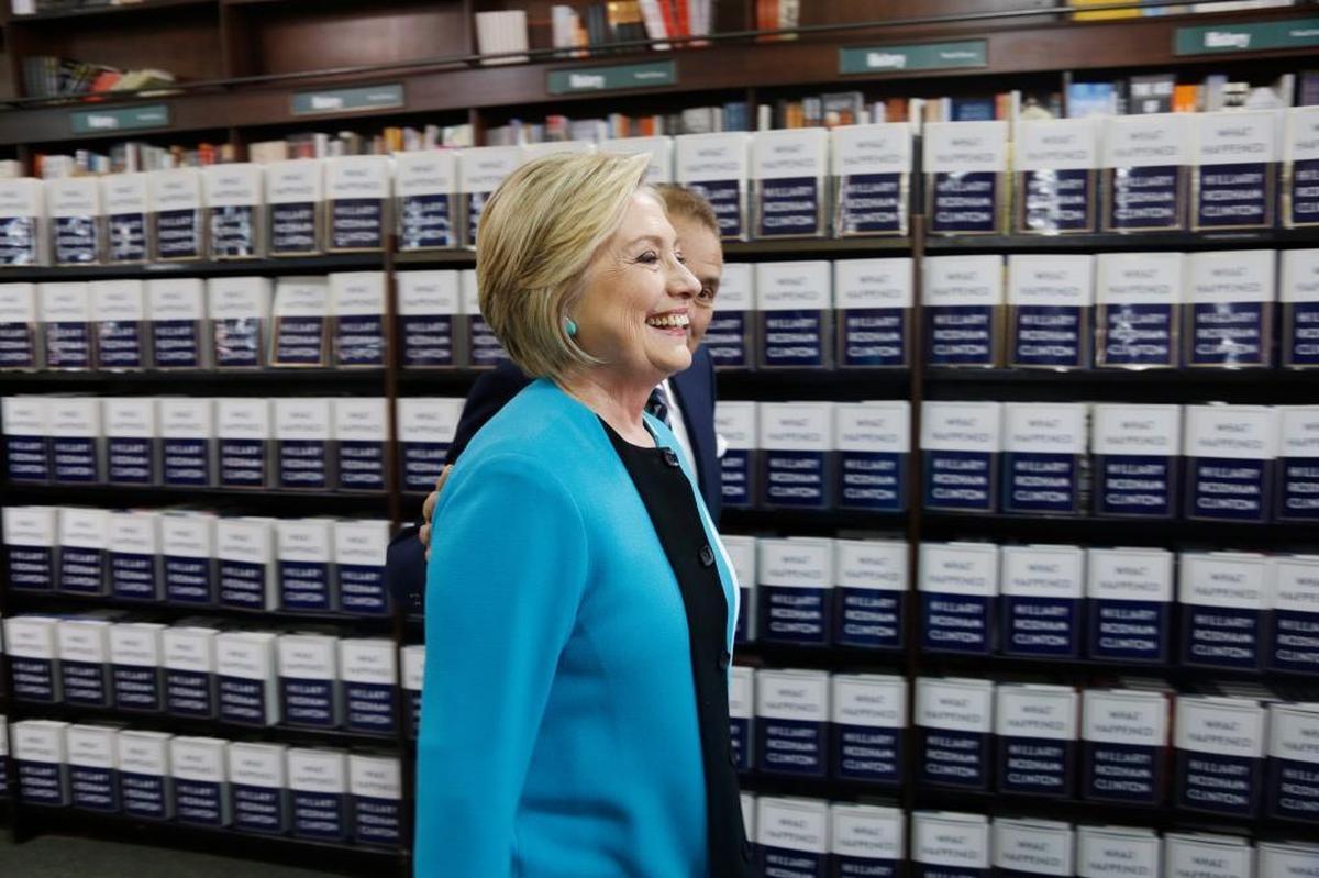 Hillary Rodham Clinton, escorted by Leonard Riggio, chairman of Barnes and Noble, arrives to sign copies of her book “What Happened” at a book store in New York. Have we argued about the book yet? No.