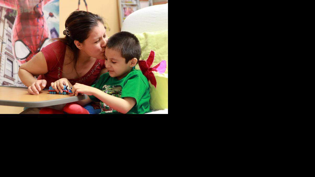 
Jaime Ponce, right, plays with his mother Deodorica Ponce on Tuesday, Dec. 23, 2014. Jaime is a 5-year-old boy waiting for a heart transplant at Joe DiMaggio Children’s Hospital in Hollywood. Jaime has dilated cardiomyopathy, but he’s also a resilient child who likes to play with cars and Thomas the Tank Engine.
