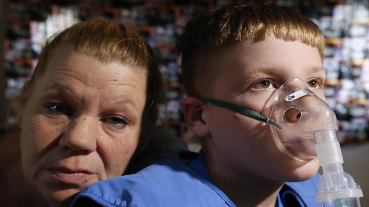 Libby Horatis, 45, is shown with her son Alexander, 12, who has primary ciliary dyskinesia (a disorder which affects the respiratory tract and abnormally positions internal organs). The two are in her mobile home in Florida City.