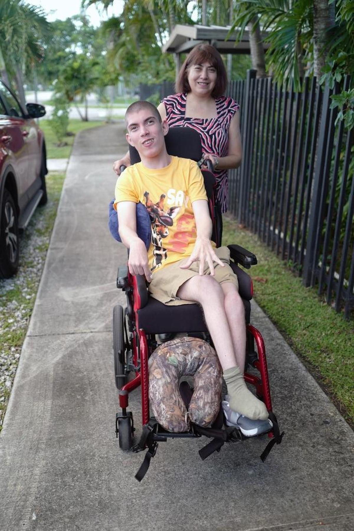 Raúl Hernández, with his mother Marta Giuliani. Raúl’s family cannot afford to buy a new handicap-accessible van with a ramp for wheelchairs.