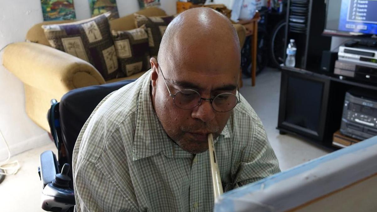 Manuel Rivera, 49, is a quadriplegic and artist who paints in his small Opa-locka apartment. He needs his old 2000 Dodge van upgraded with machinery to help him board easier.