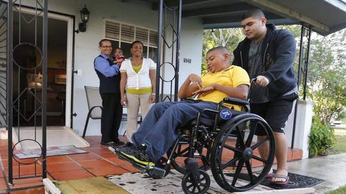 
Jerald Garcia’s uncle Eric Hernandez pushes his chair up the ramp in front of their home. Jerald, 12, has cerebral palsy. His family built a wooden wheelchair ramp six months ago, but the ramp is now damaged.
