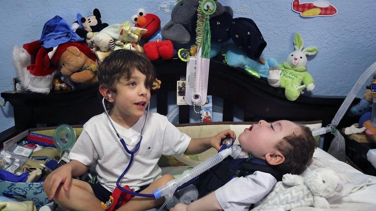 Adrian Quesada, 5, left, plays doctor with his twin brother, Alejandro Quesada, whose disabilities include cortical visual impairment, bilateral retinopathy of prematurity, brain atrophy and optic atrophy, on Thursday, Dec. 21, 2017. Alejandro is in need of a new medical bed, a special car chair, and other items due to his medical condition.