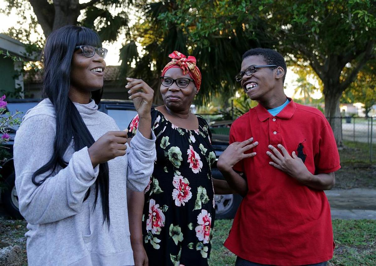 Ivrose Thelusmond, with her children Wunier Joseph, (right) 20 y.o and Nehemie Pierre, 25 y.o, stand in front of the house of some relatives they are staying with after some family financial difficulties. For Wishbook, on Tuesday November 27, 2018.