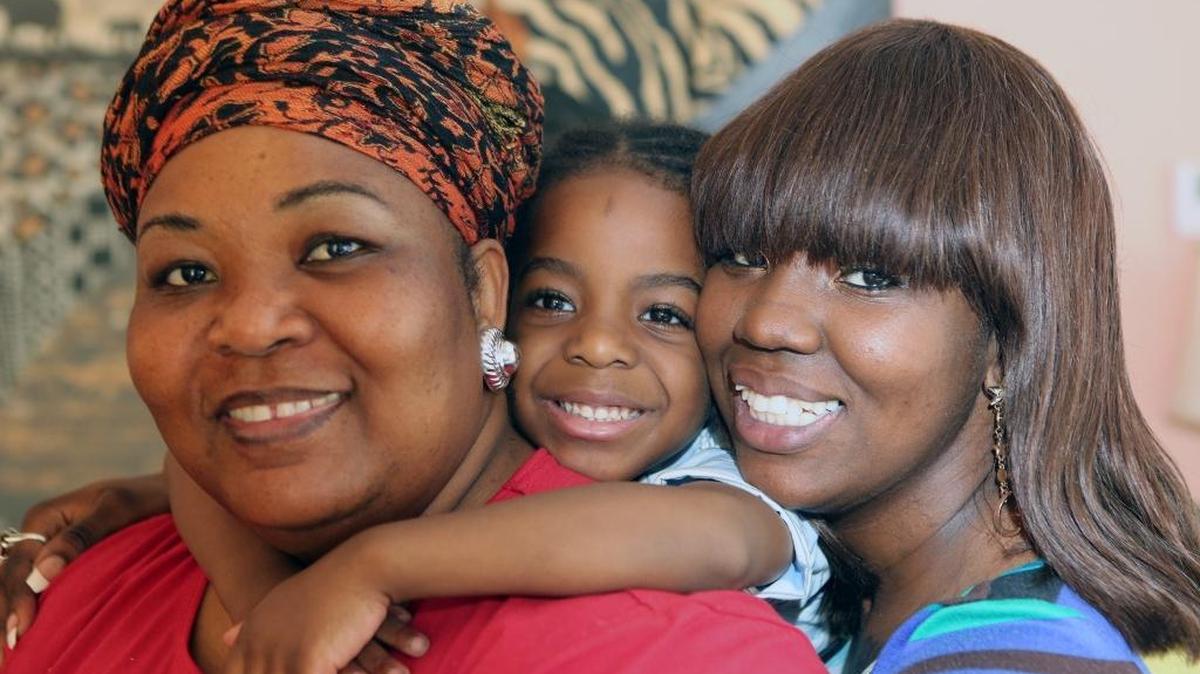 From left, Denise Vincent (grandmother), Ezra William Moise, 5, and Britania Jacques. Jacques was in a car accident, and has tried to remain upbeat despite chronic health challenges. She is also back in school, studying at Barry University. But she always makes time to help out in her son’s school.