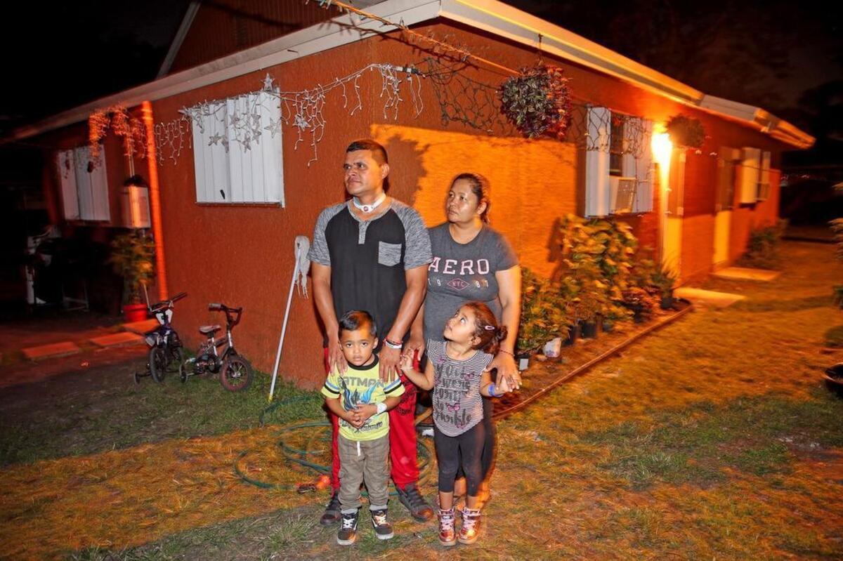 José Chávez, with his wife, Marilú Berrios, and their 4-year-old twins, Atzel and Itzel, in their Homestead home. Life for the Chávez family has been a struggle after José was shot in the neck by a drive-by shooter in April.