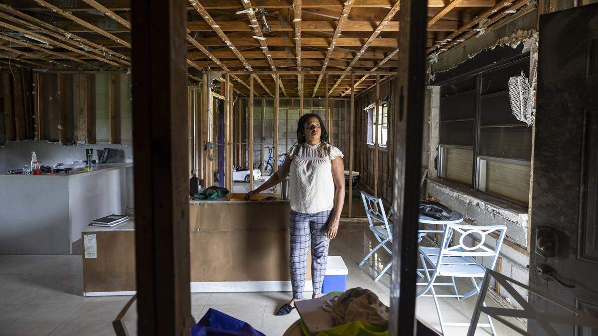 Pauline Dufresne, 39, is photographed in what used to be her living room on Wednesday, Nov. 5, 2025, in Miami, Fla. Dufresne, a Haitian TPS holder, lost her home to a fire in July and, without insurance, has been left without power, running water or a place to live. She and her four children are temporarily staying with a nearby neighbor.