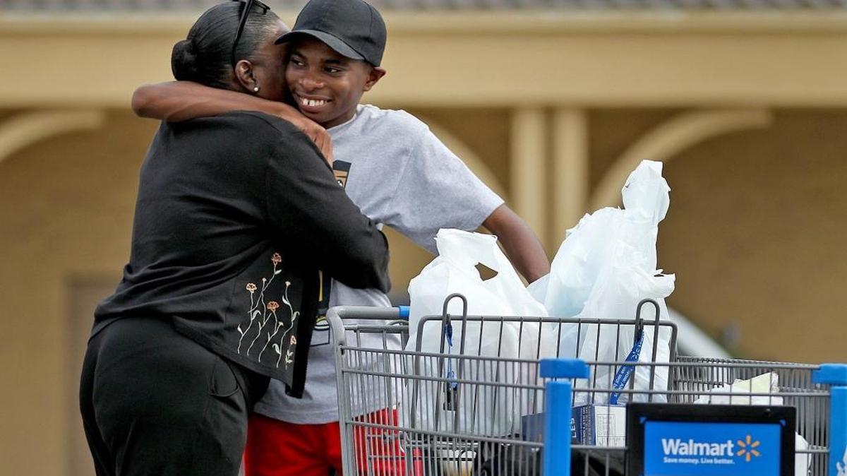 Reshelle Burns Davis does a little grocery shopping with her son Edward Burns Davis on Dec. 10.