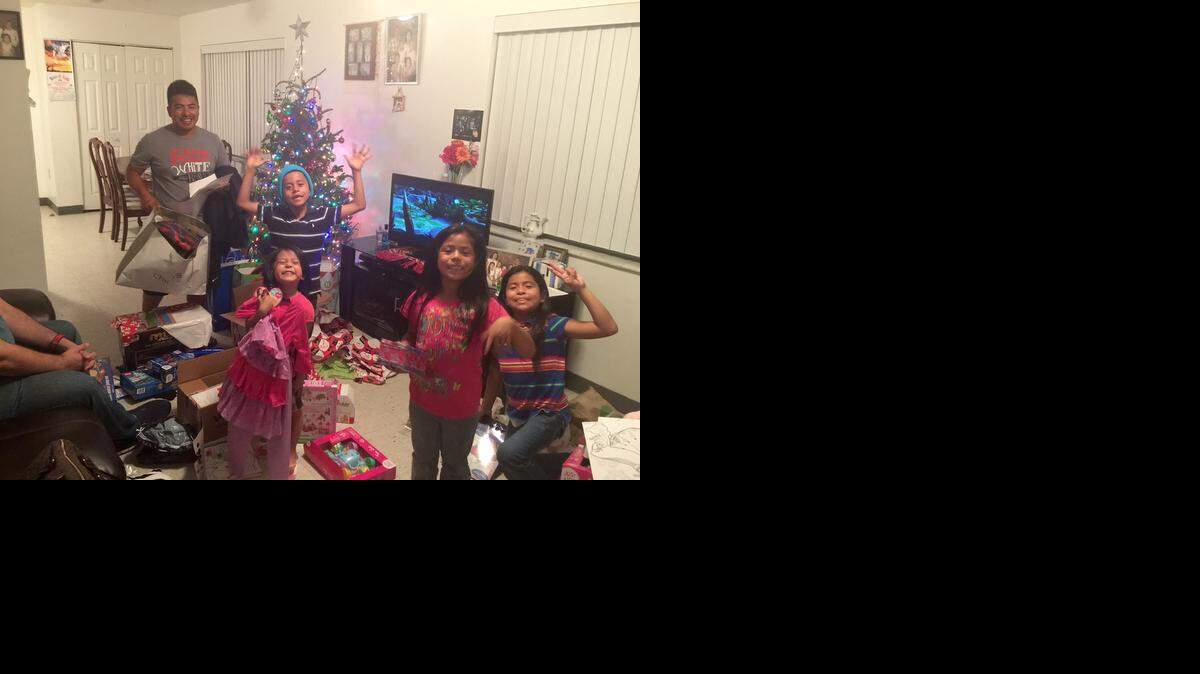 
HAPPY HOLIDAY: The Atjum family celebrate Christmas with some gifts that came pouring in to their Florida City home from the Zamudio family and a group of friends after readers learned of their plight via a WLRN-Miami Herald Wish Book story. In July, the children lost their mother Veronica in a car accident. Dad Lucas Atjum (top left), a farm worker, is now raising their kids, Leonardo, 7, Margarita, 8, Francisca, 6, and Bani, 4. Donors provided bunk beds, funds, catering for a holiday meal and Bay Oaks Seniors Home offered to provide birthday gifts to the children throughout the year.

