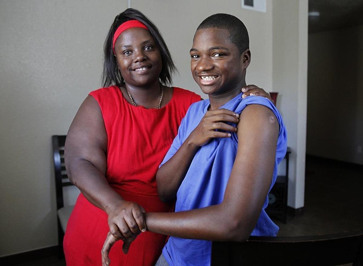 Devontae Antwan Hemans shows his bullet wound as his mother, Latrese Williams, holds his hand. The wound was made by a stray bullet from a drive-by shooting in October. Doctors say removing the bullet would cause more damage than leaving it.