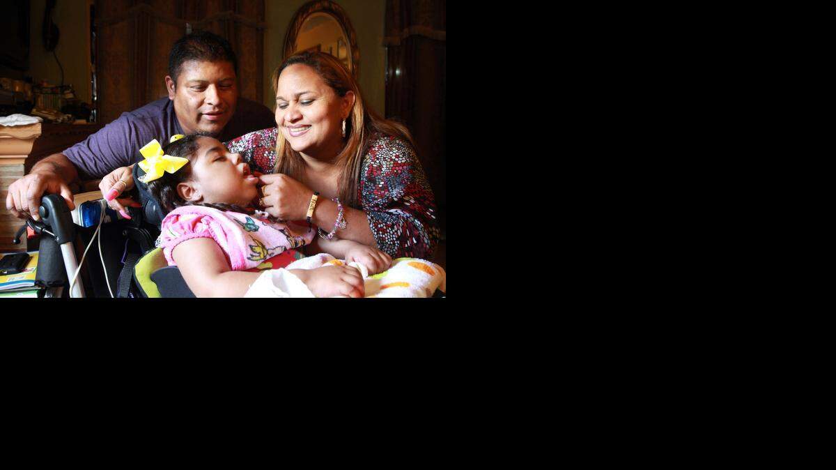 
Ruth and Jose Herrera care for their 4-year-old daughter Lesly, who has cerebral palsy and cannot walk. A nurse comes to their home every day to help care for her. Their son Alan, 3, has autism. The couple has adult children, but they decided to adopt Lesly and Alan, children of Ruth's cousin in the Dominican Republic, to care for them.
