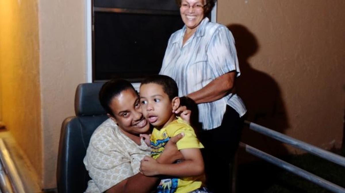 Ramona Raquel Nuñez, her son Emanuel Nuñez, and her mother Ana Padills outside their South Miami-Dade home.