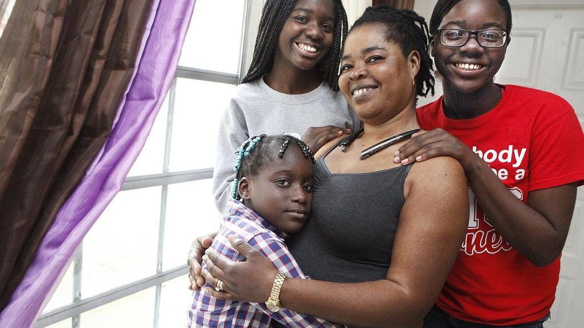 Judith Fortulien, center, is surrounded by some of her children on Saturday, Dec. 10, 2016, in their Sunrise rental home. Clockwise from lower left are Samantha Fortulien, 8, Kishana Cesar, 13, and Sandra Cesar, 15.