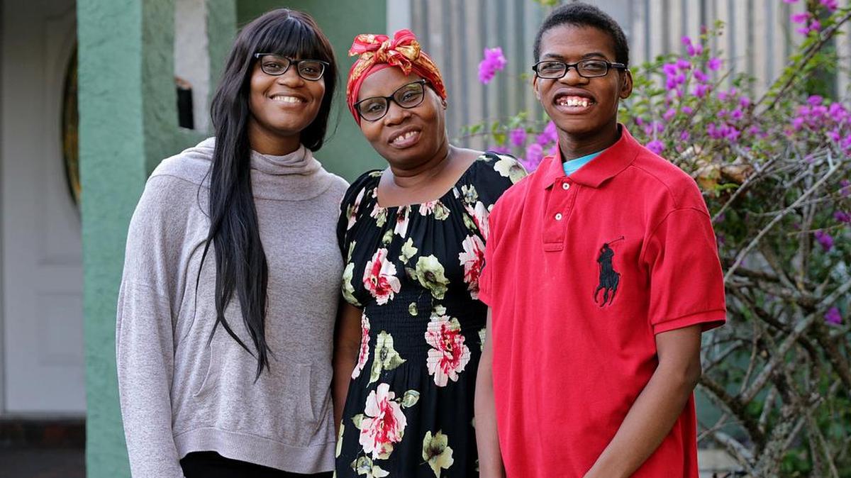 Ivrose Thelusmond, center, with her son, Wuiner Joseph, and daughter, Nehemie Pierre, in front of the house of relatives....