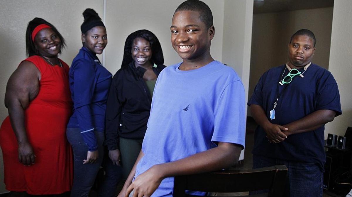 Devontae Hemans at home with his family: (from left) his mother Latrese Williams, sister Bre’yonna Williams, Deneisha Harris, Hemans and Joshua Sampson. A stray bullet from a drive-by pierced him in early October, and he still has the bullet in his body. He and his family no longer feel safe outside.