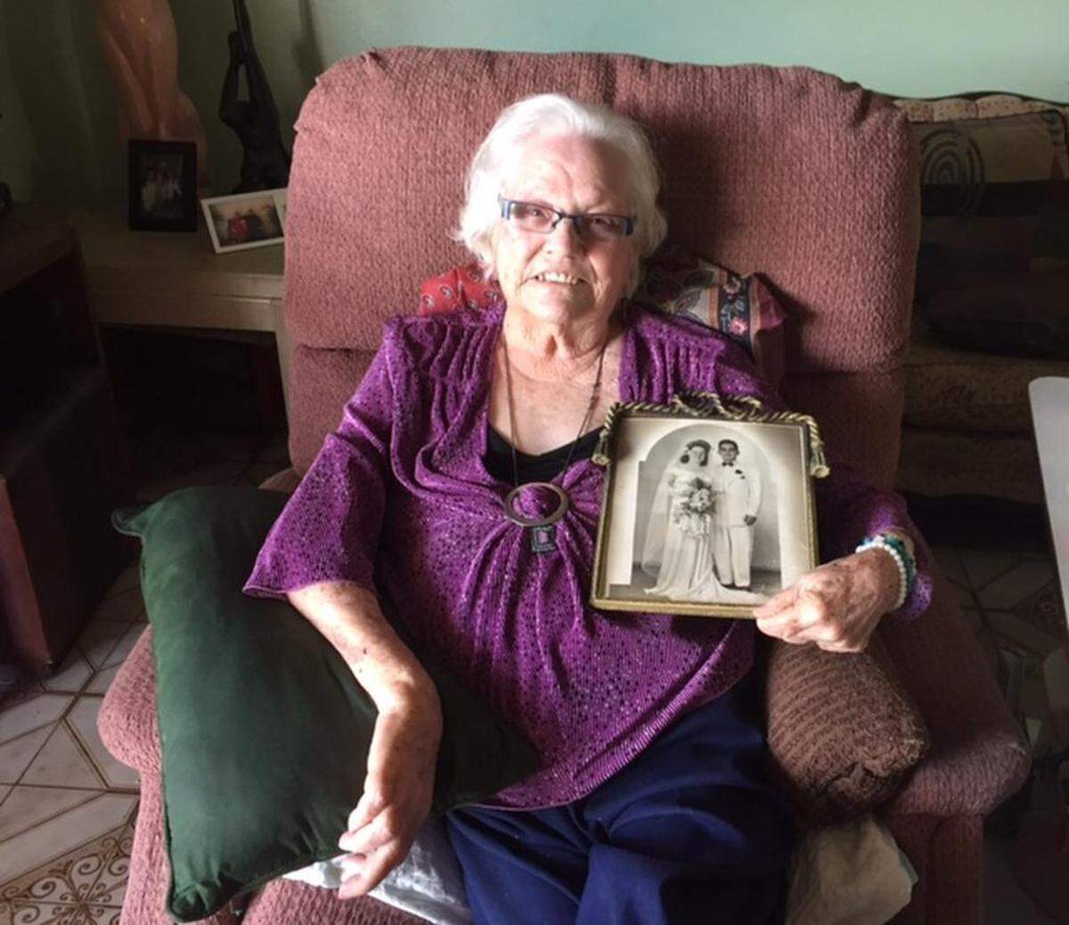 Norma Minsal shows a photo of her wedding with her husband Esteban, now deceased.