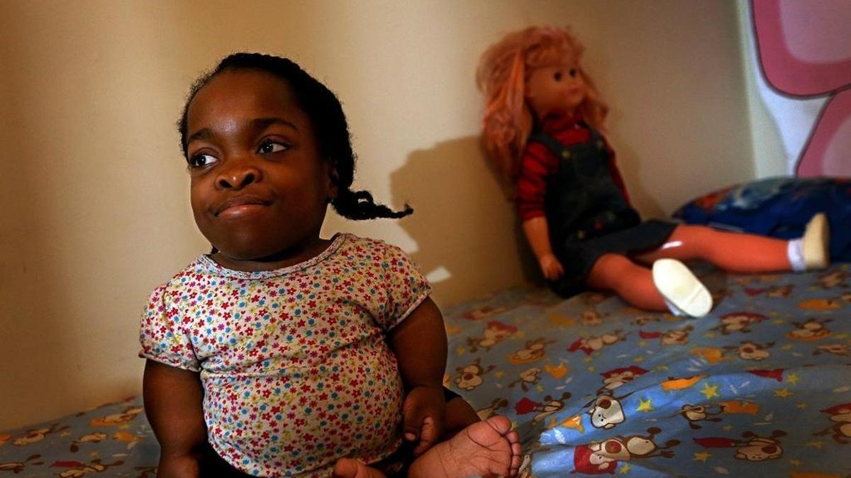 12-year-old Wildine Aumoithe sits in her bedroom. She could use help to make her home more accessible.