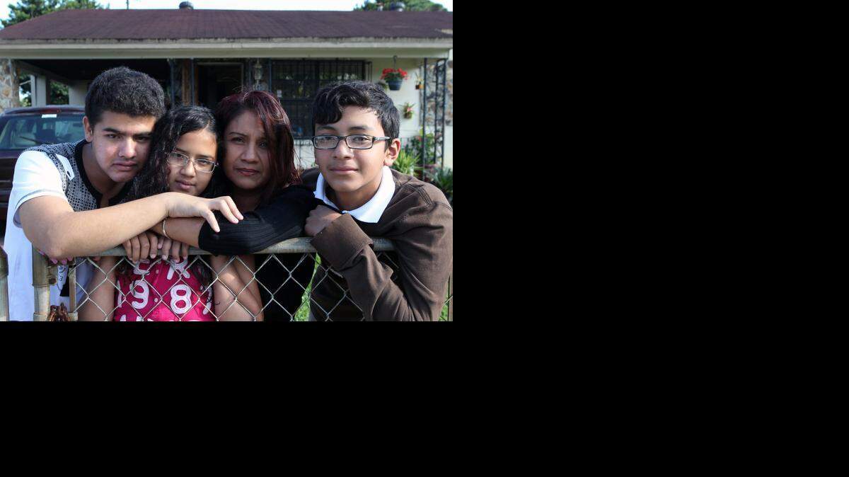 
 FAMILY LIVES A MORE TRANQUIL LIFE NOW: From left: Wilfredo Santamaría, 18, Yael, 11, Yael Avalos (mom), and Daniel, 14, in Opa-locka. 


