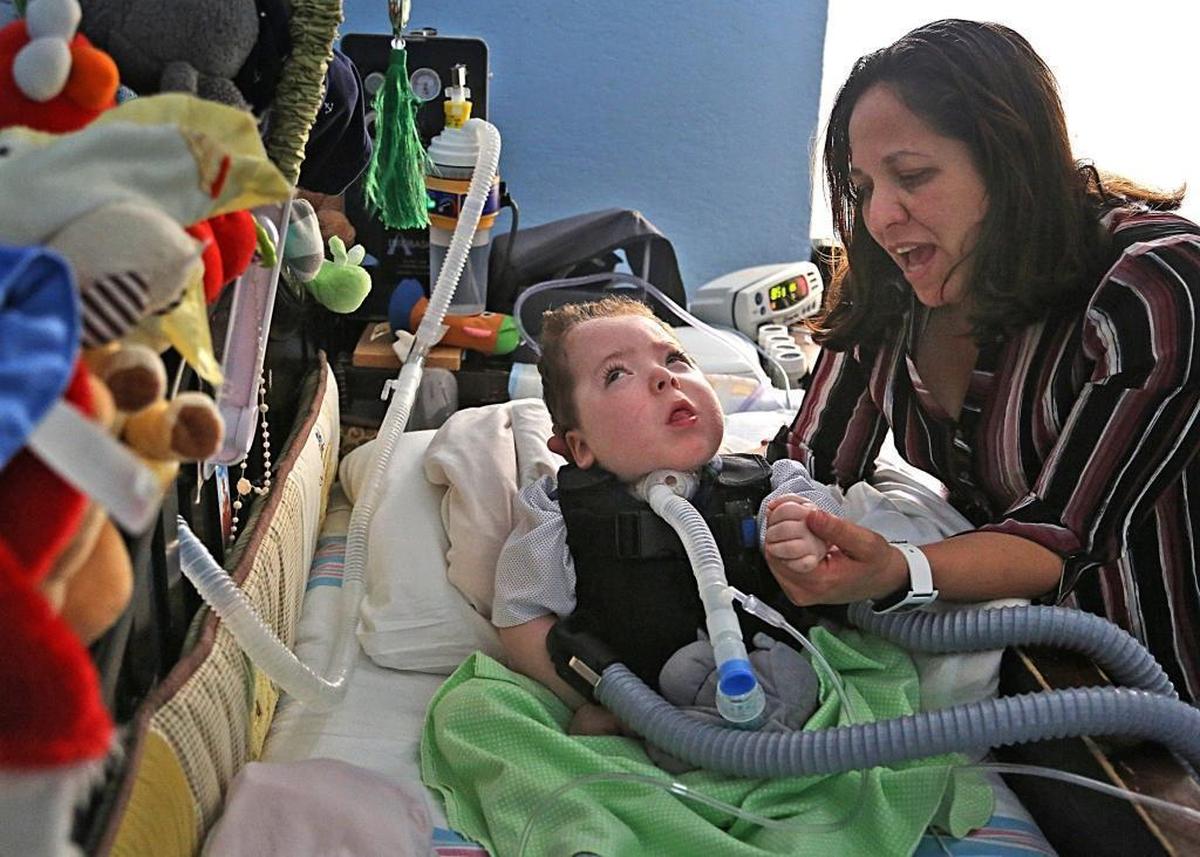Alejandro Quesada, a 5-year-old old twin boy with a diagnosis of cortical visual impairment, bilateral retinopathy of prematurity, brain atrophy and optic atrophy, is attended by his mother, Lizzette Jimenez, on Thursday, Dec. 21, 2017. Alejandro is in need of a new medical bed, a special car chair, and other items.