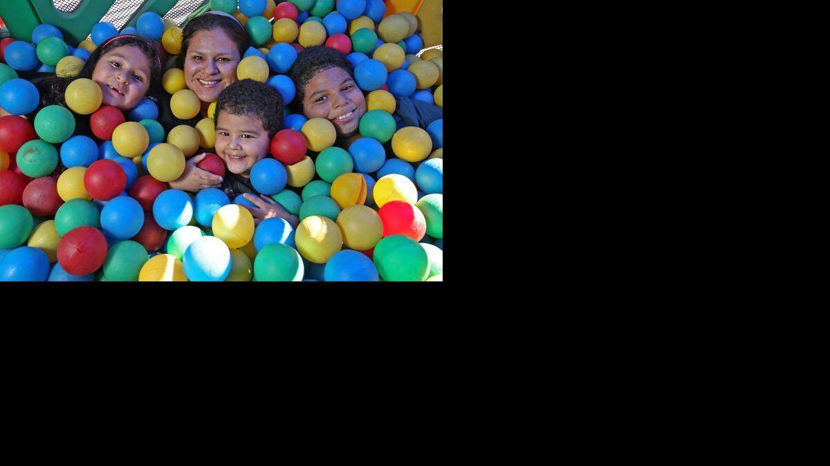 
Genesis, 7, Nancy Araujo, 37, James, 2, and Matthew, 10, play at school.  Nancy Araujo  has been balancing her finances by faith.
