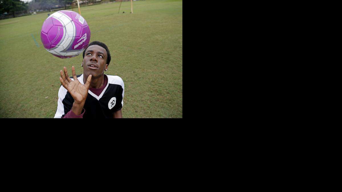 
Stanley Simon tosses a ball in the air at Pine Island Park in Plantation on Tuesday, Nov. 18, 2014.
