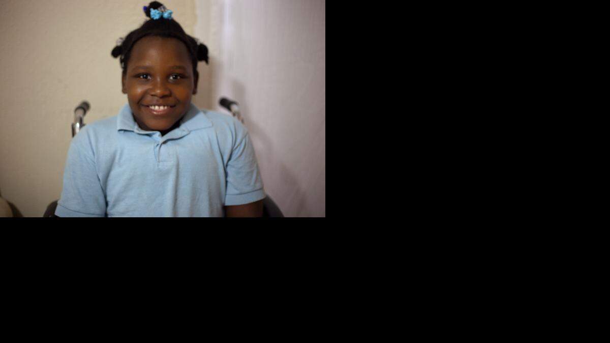 
Guychar Nicaisse, 8, lives with her mother, Charline Francois, in a temporary home in Little Haiti that’s provided by Catholic Charities of the Archdiocese of Miami, Inc. Guychar is confined to a wheelchair after being injured in the massive earthquake in Haiti in 2010.
 
