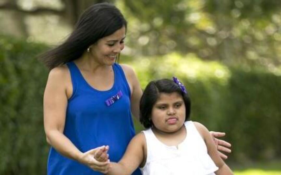 
Claudia Rabinowitz and her husband struggle physically to get their 8-year-old daughter, Isabella, around the house. Isabella has Rett Syndrome, a neurodevelopmental disorder that causes seizures and affects motor skills, speech and the ability to walk. Isabella is 8 and weighs 94 pounds. Mom is a cancer survivor and is recovering from complications of a double mastectomy, and dad is a nurse who works 12-hour shifts three days a week. This is outside their home in Coconut Creek on Thursday, October 30, 2014.
