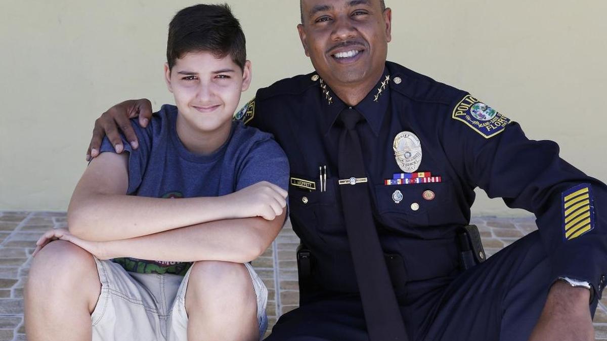 Maykel Sosa, 11, with Ian A. Moffett, Chief of Police, Miami-Dade Schools Police Department.