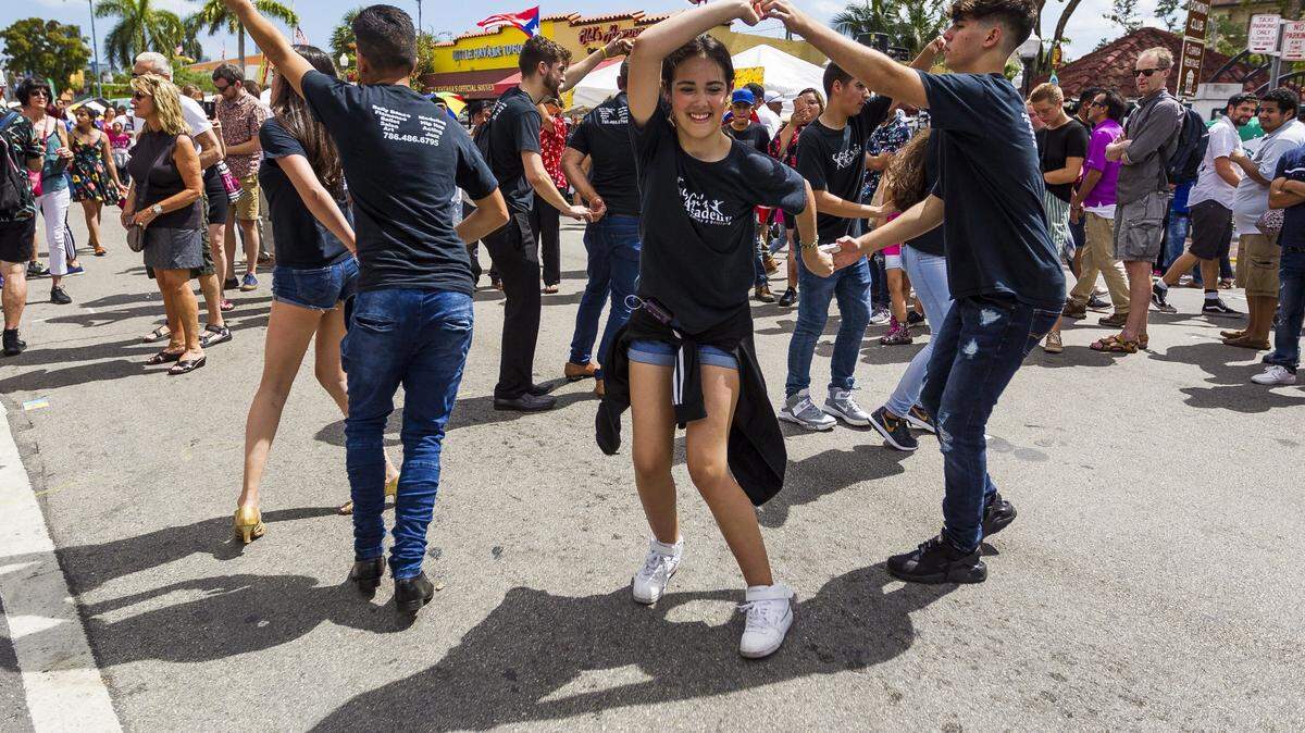Rachel San Jorge and Antonio Mari (center) dance up a storm at Calle Ocho in Little Havana in March 2018.