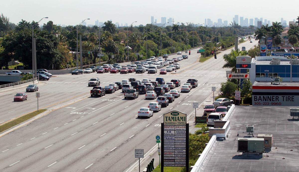 When the light turns green, a driver in the middle lanes will attempt a right turn.