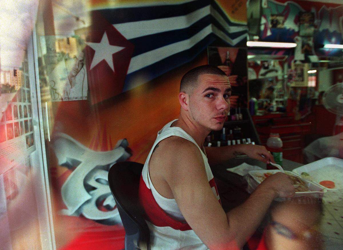 01/30/03 -- Barbara P. Hernandez / For the Herald -- Miami: Up and coming rapper, Pitbull, at his favorite barber shop, a grafitti-walled Little Havana hub where he gets a 12-dollar fade cut. Althought he’s yet unsigned, his records are blowing up the radio charts. (2 of 2)