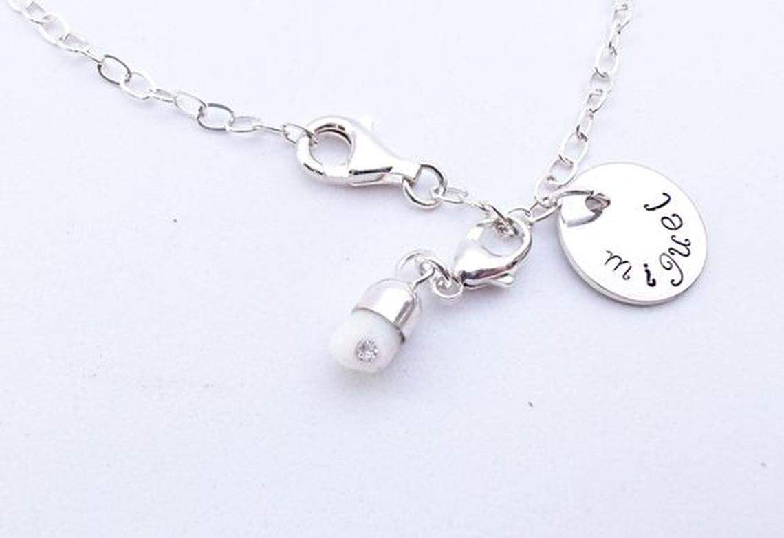 This is a necklace with your baby's tooth on it. Nothing weird about this AT ALL.