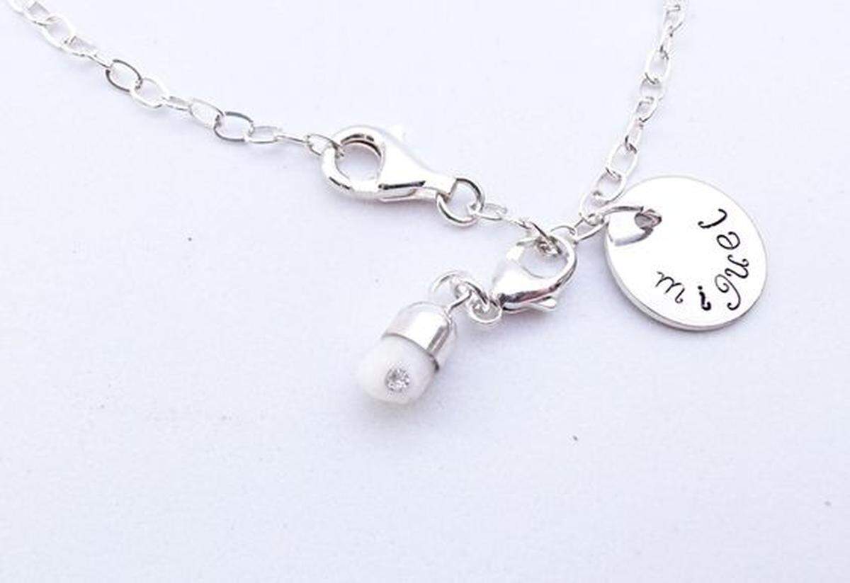 This is a necklace with your baby's tooth on it. Nothing weird about this AT ALL.
