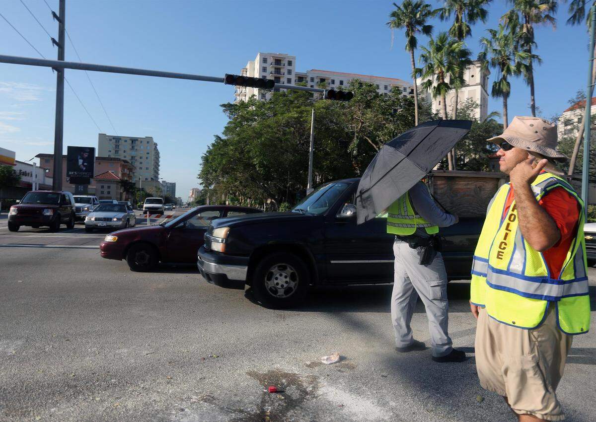 Coral Gables police officers direct traffic at Alhambra Aveue and Eight Street because a hurricane came and wiped away all our common sense... just kidding; we could never drive.