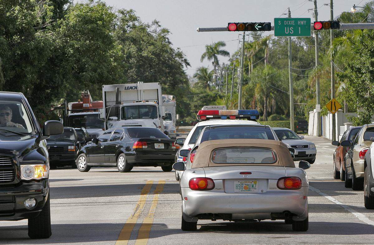 Literally none of these drivers are using their turn signals. Not even the the cop. VanBeekum/Miami Herald Staff