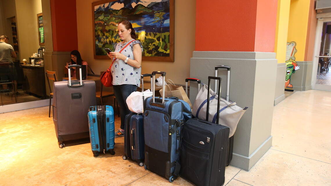 Just about everybody at the Dolphin Mall has a suitcase. We asked why.