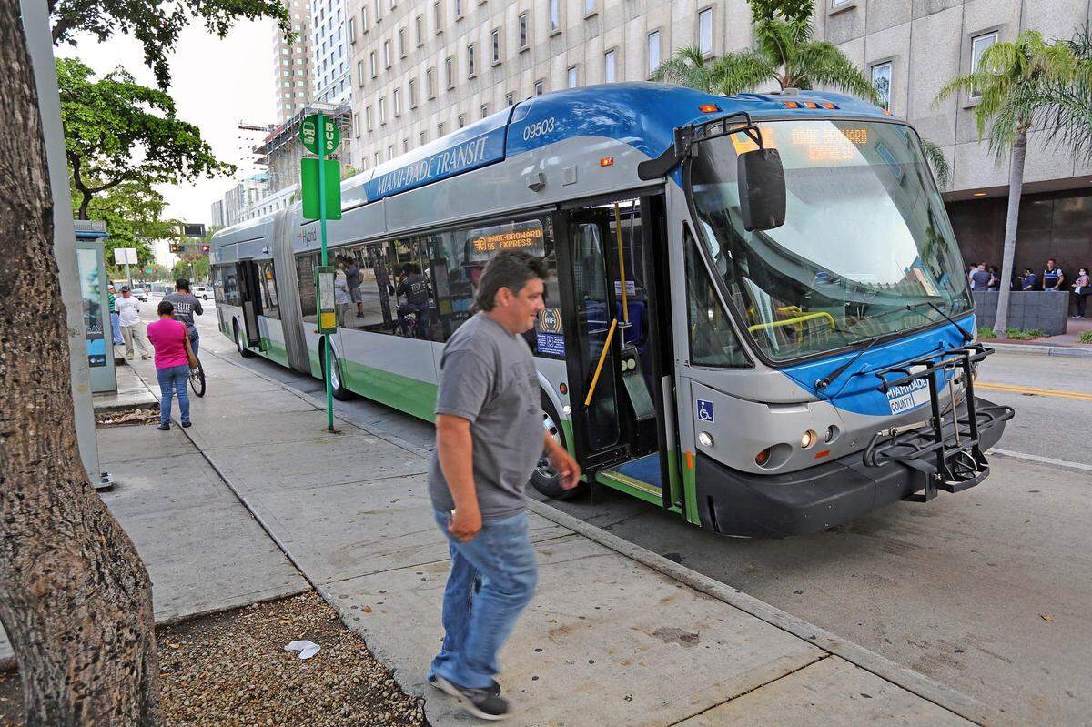 That driver in the car at the light is trying to figure out the quickest way to get from behind that bus.