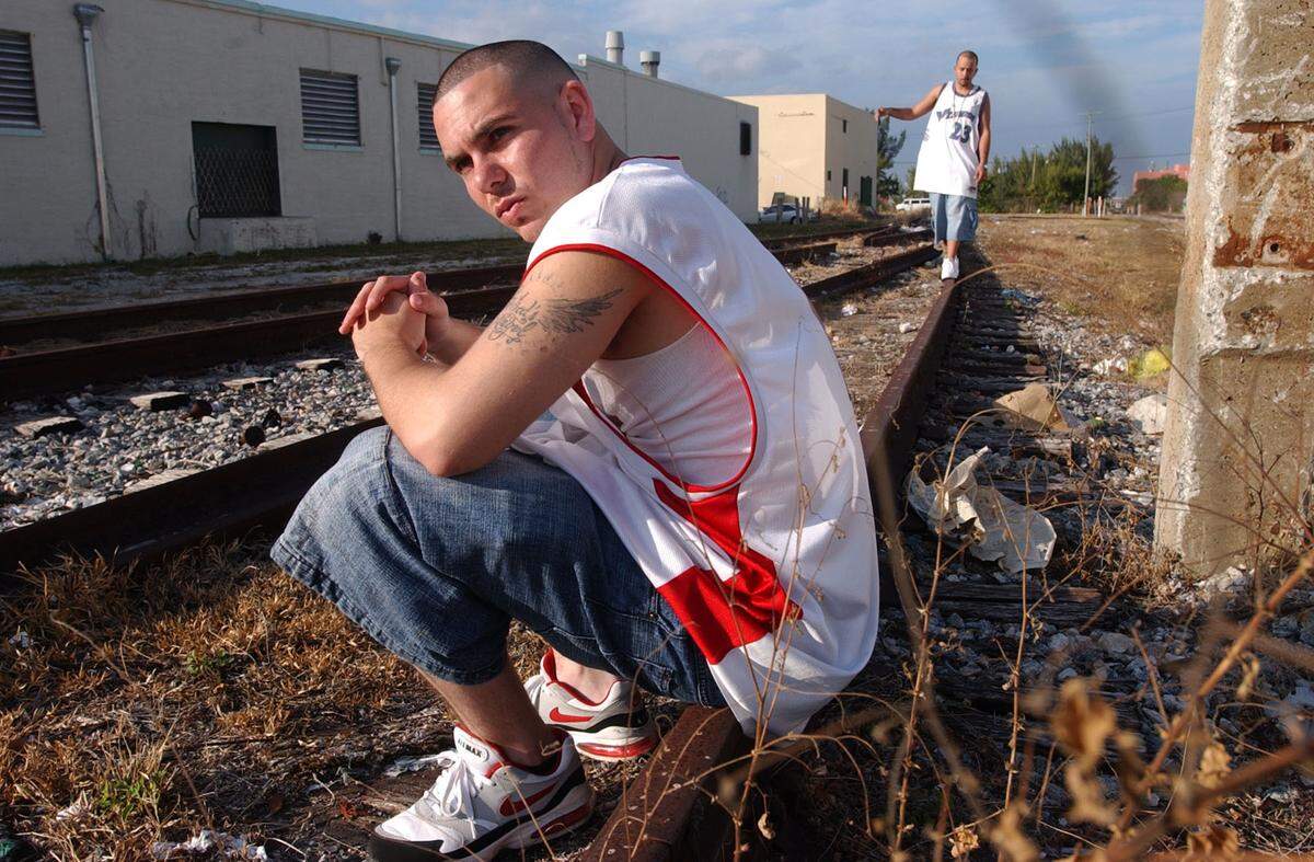 02/04/03--MARICE COHN BAND/MIAMI HERALD STAFF--MIAMI; Pitbull, a rapper, hangs in the neighborhood he grew up in. His mother’s house, 25 N.E. 28th Street, a forgotten Miami area. Behind him on the tracks is Cubo. SOUTH FLORIDA (2 of 2)