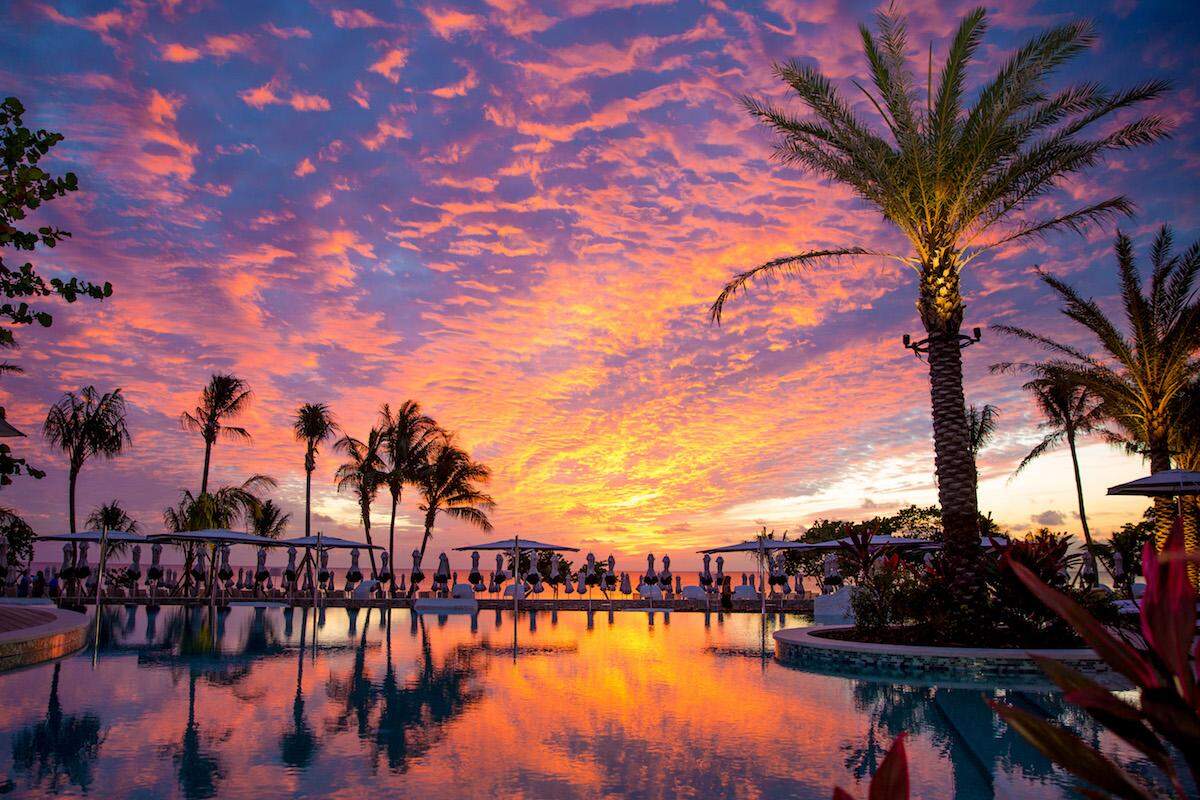 A stunning sunset over Grand Cayman's Seven Mile Beach at the Kimpton Seafire's pool.